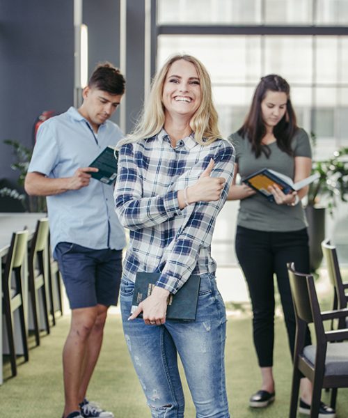 laughing-college-girl-in-library